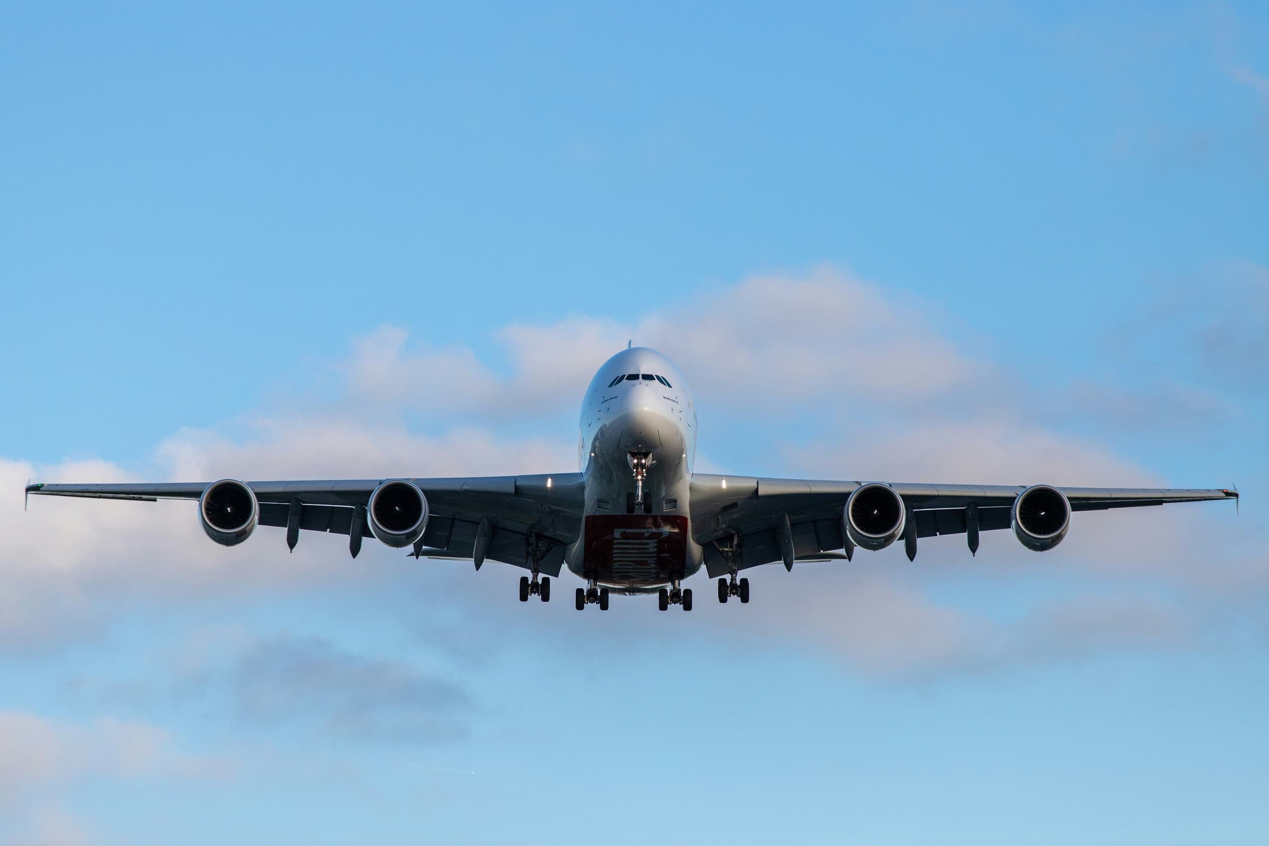 An airliner on approach against a clear sky